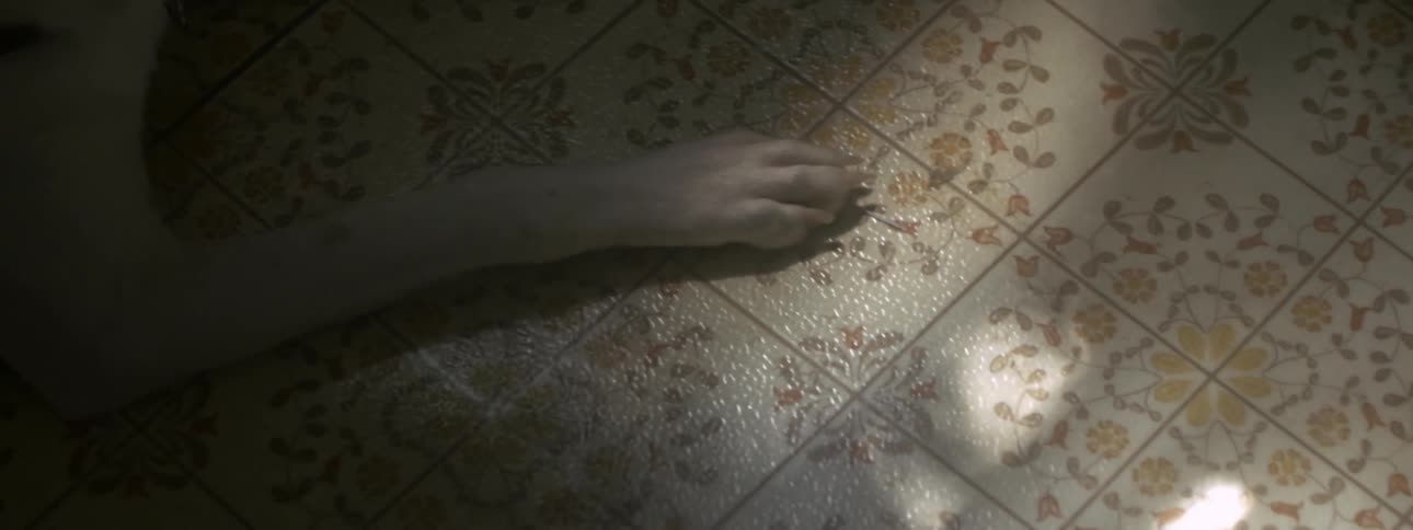 A dog's paw on a tile floor