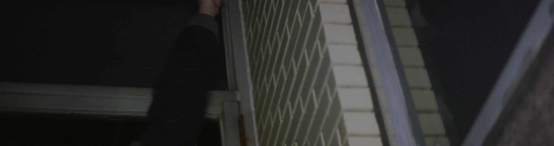 A man in a jacket dancing in a corner