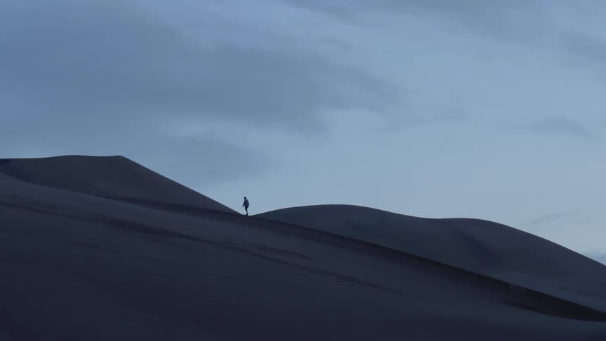 A man walks alone in the dune