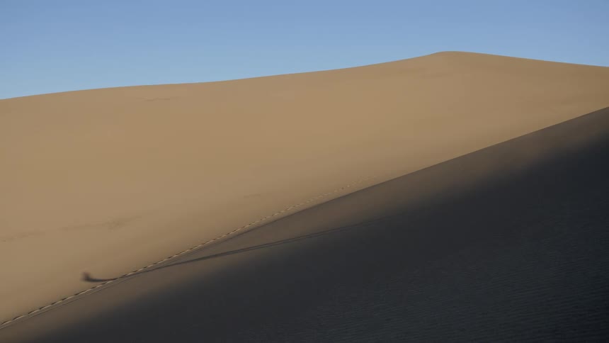 A scenery of a wide dune on a clear day