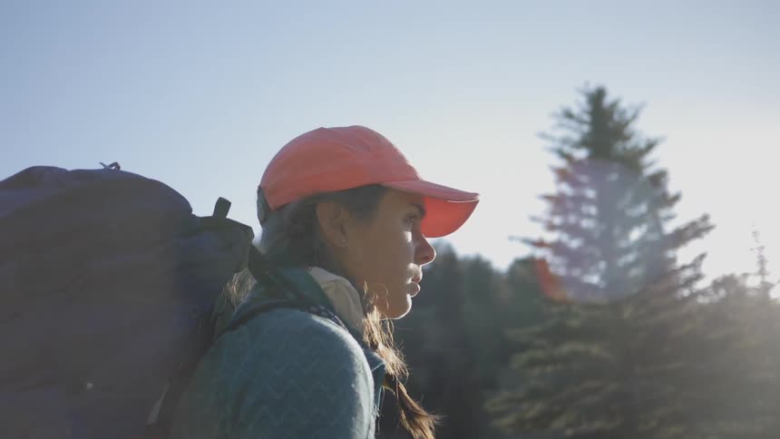 A woman hiking alone trough the forest