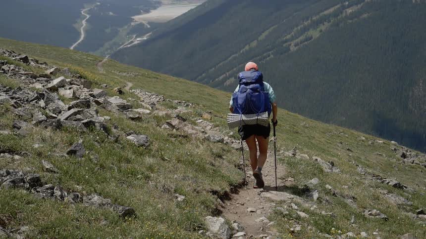 A woman hiking alone on the mountain