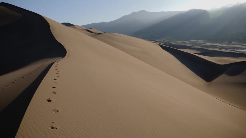 Footsteps on the surface of sand dunes