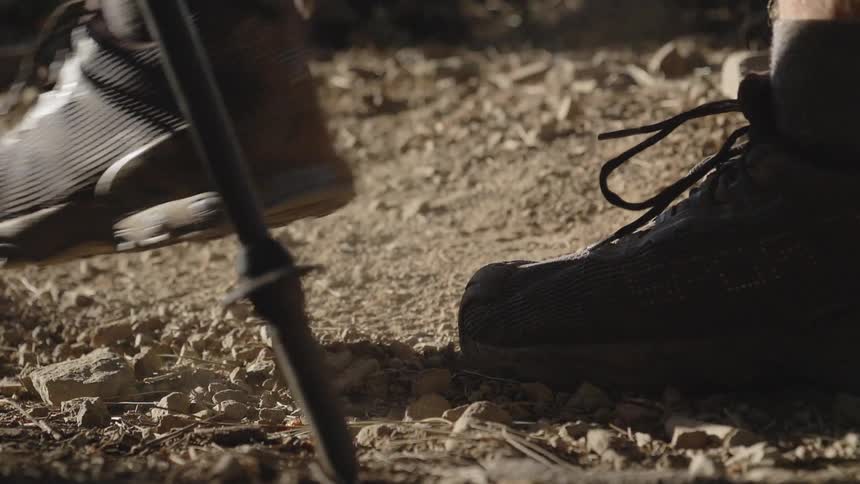 A close up footage of a foot of a hiking man