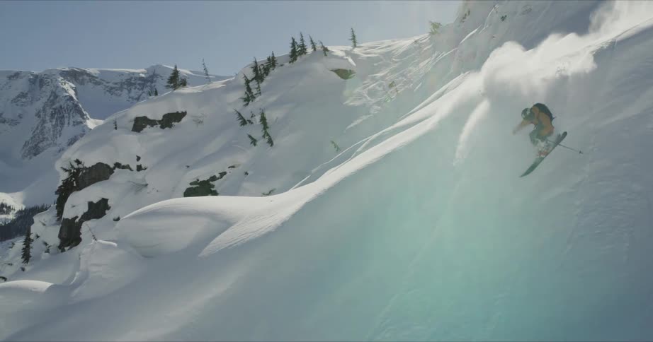 A man doing a snowboarding at the snowy mountain