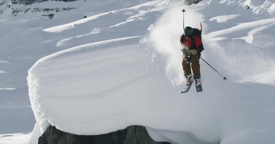 A skier jumps off a rounded slope