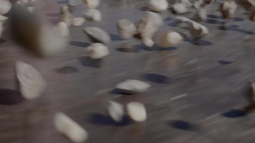 Rocks tumble over a spinning surface