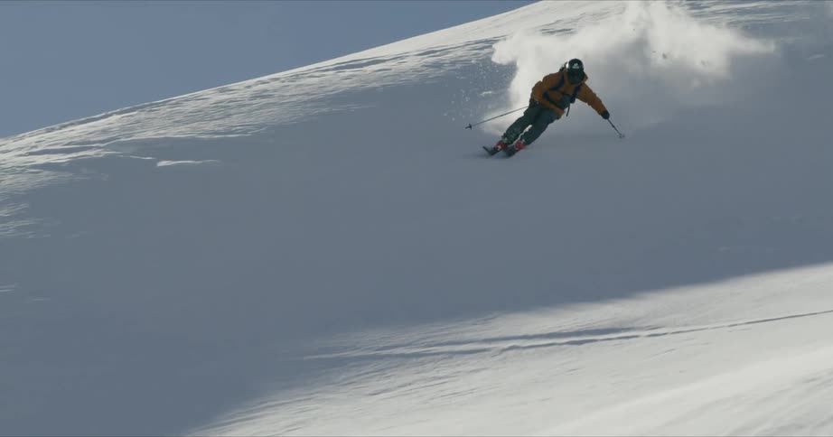 A skier jumps through the air and lands smoothly