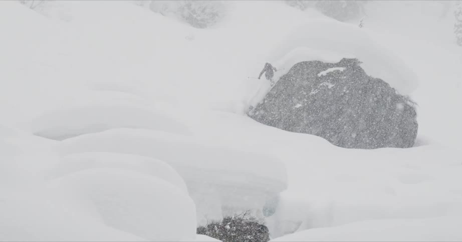 A man skiing on the heavy rain snow