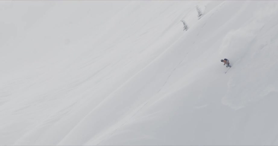 Skier skiing down a heavy snow covered mountain