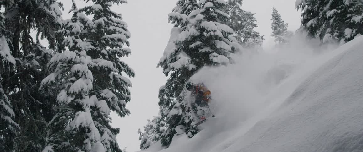 A person skis down a treacherous snowy mountain slope