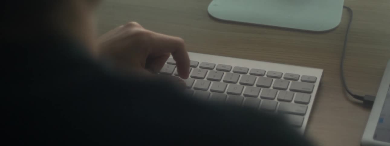 Someone holding their hand over a keyboard