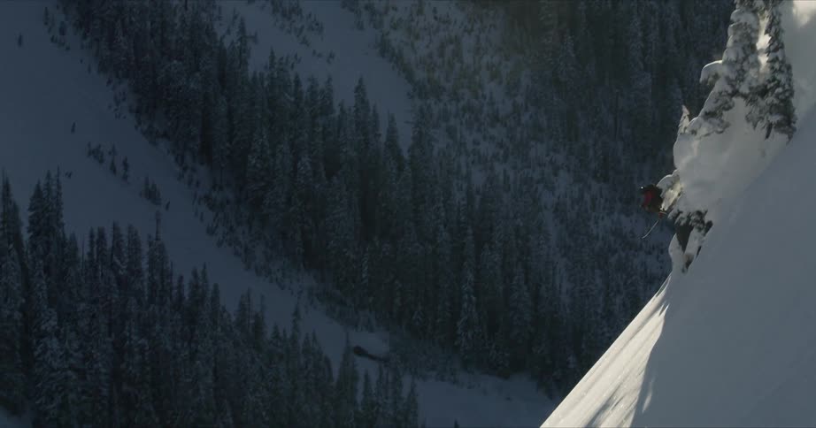 A man doing a snow boarding on the snowy mountain