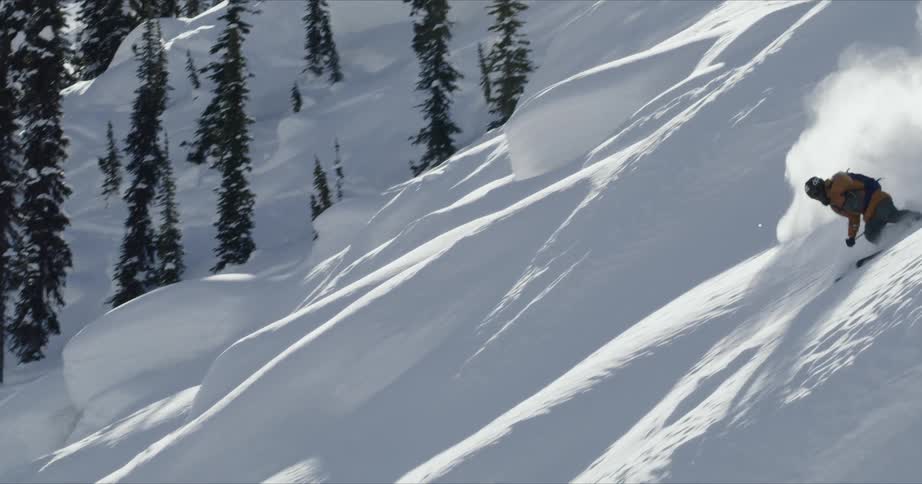 Man doing a ski trick on the snowy hills