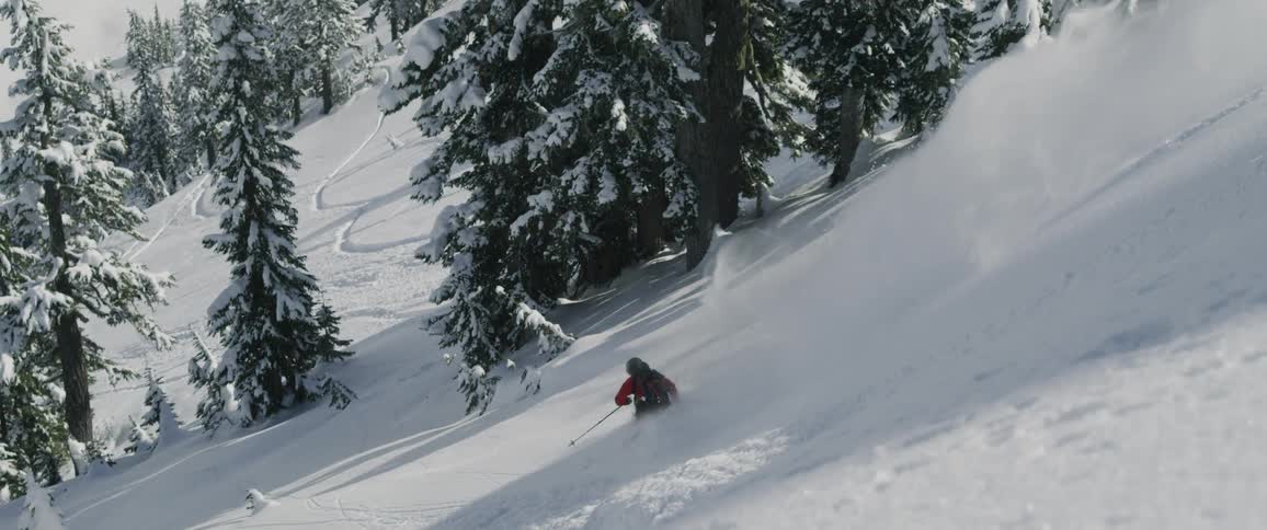 A person is skiing down the slope very fast