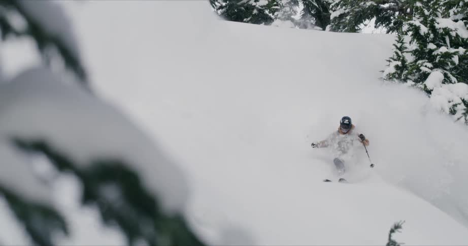 A man snow boarding on the snowy hill