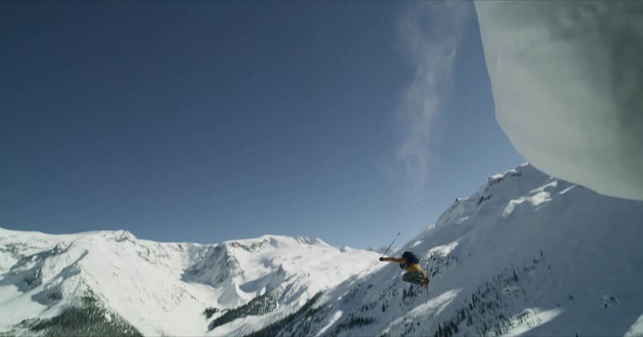 A person jumps down a hill on skis