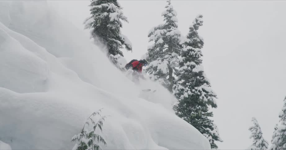 A man doing downhill with a snow board