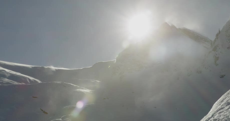 A scenery of a snowy mountain under the harsh sun light