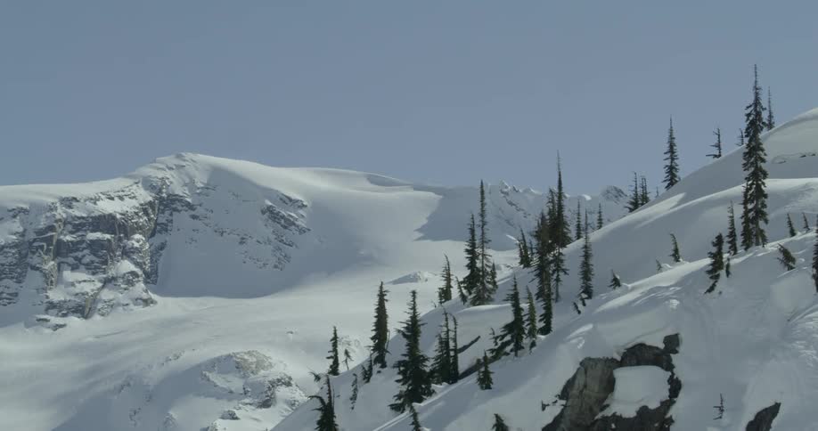 A scenery of a snowy mountain peak on a clear day