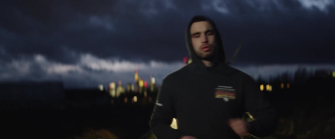 A man is jogging outdoors at night