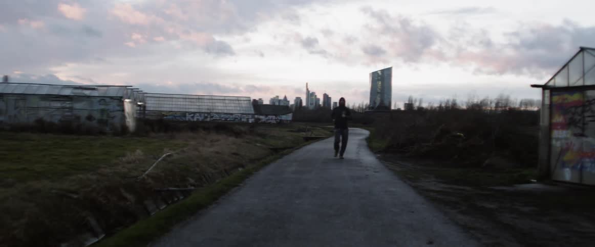 A man jogs down a deserted roadway
