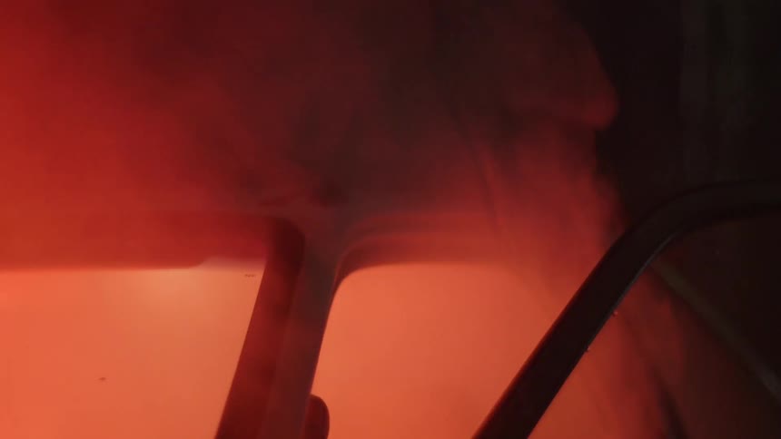 Bright orange smoke coming out of a car