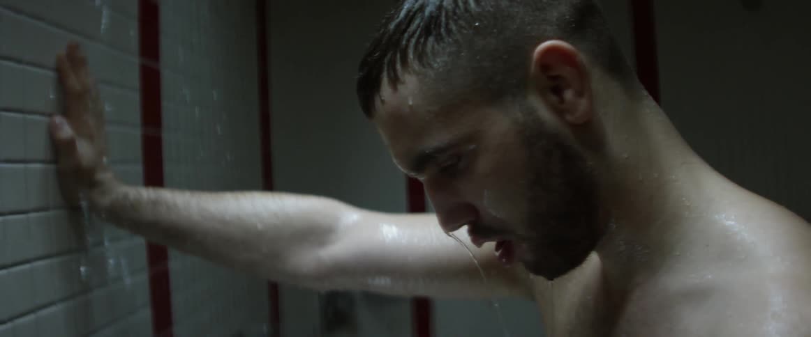 A man is taking a shower in a bathroom