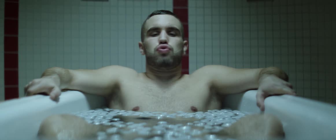 A young man soaks in the cold ice water
