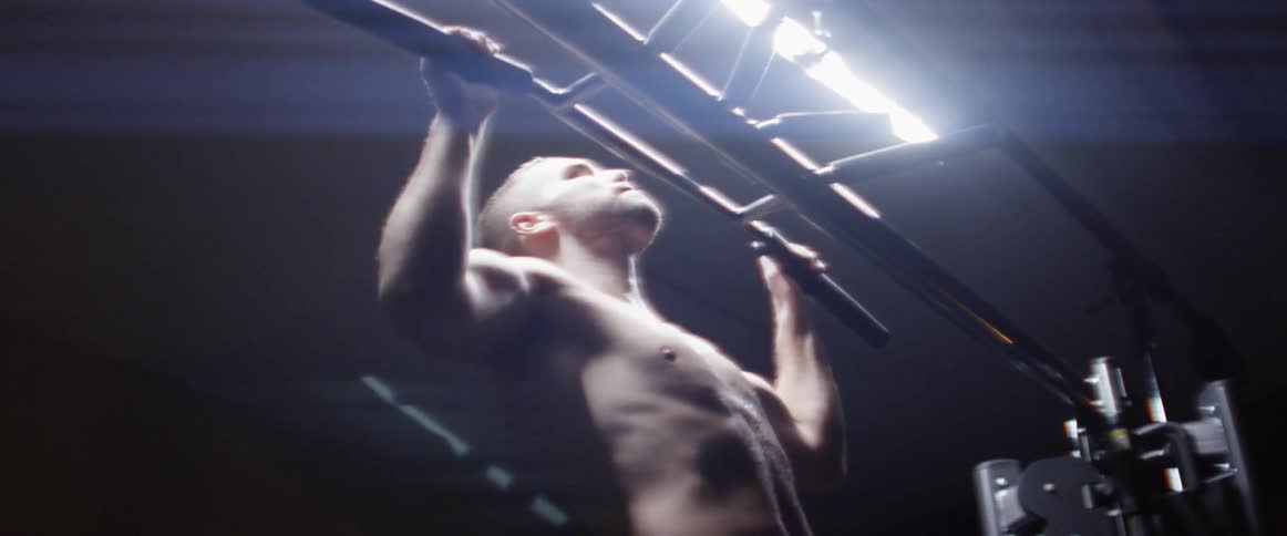 A shirtless man doing workout at the gym