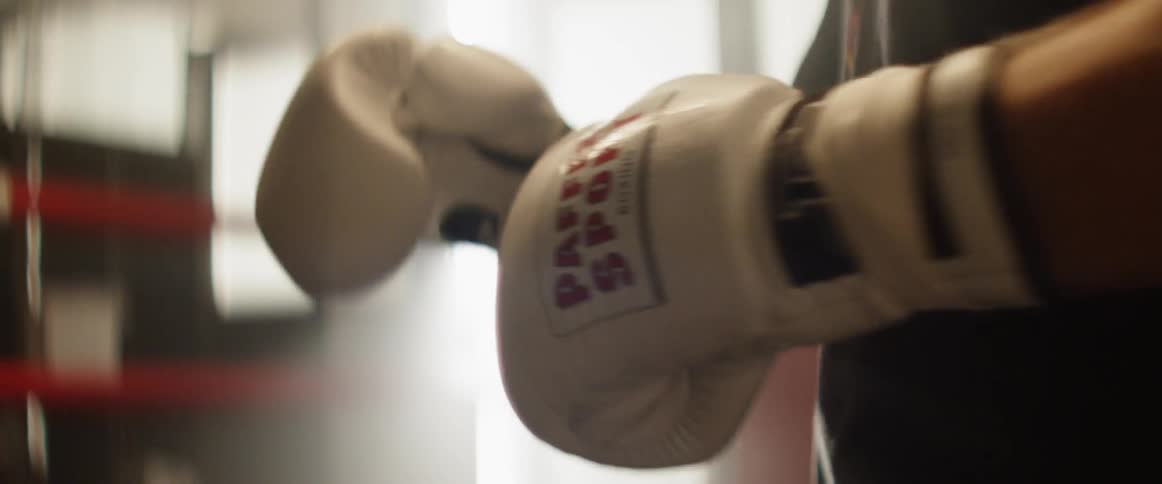 A boxer prepares to fight and hits his gloved hands against each other
