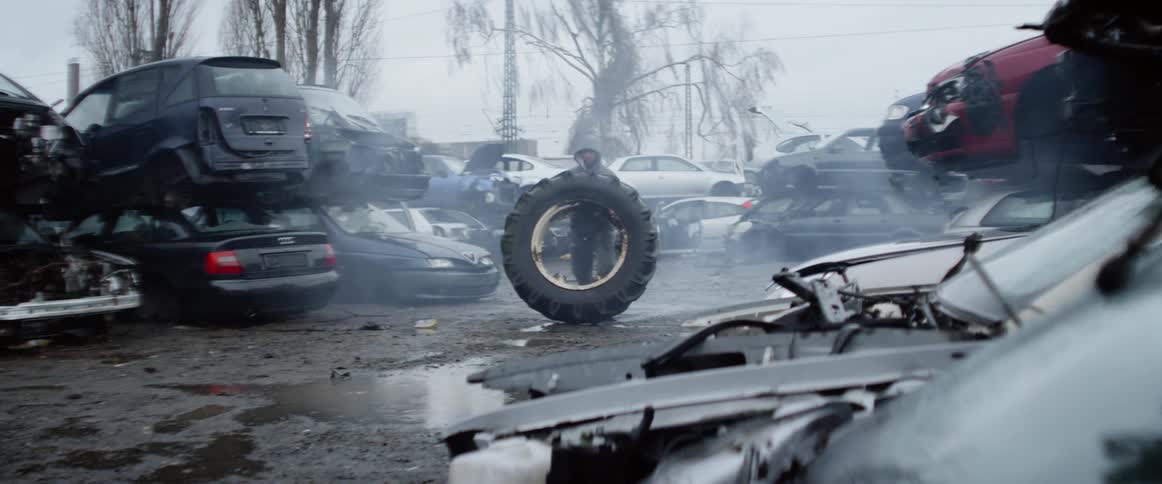 A man training by lifting truck tire