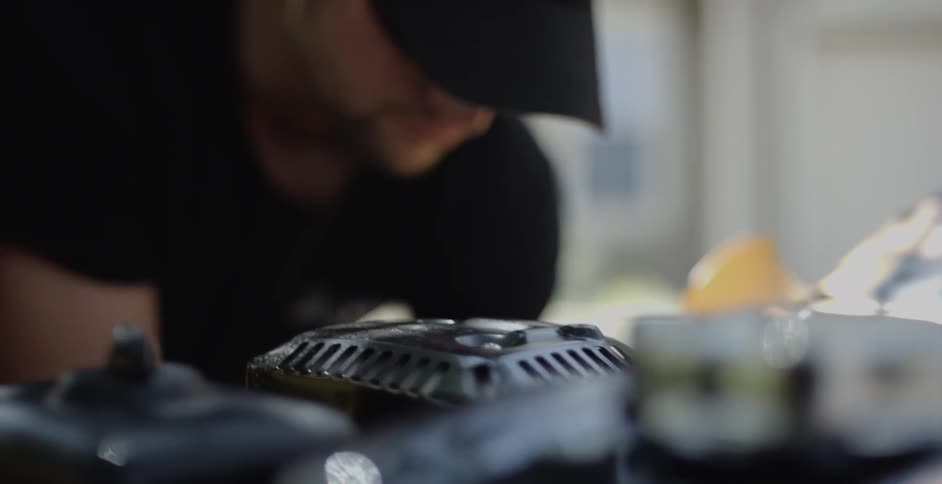 A person stands next to machinery