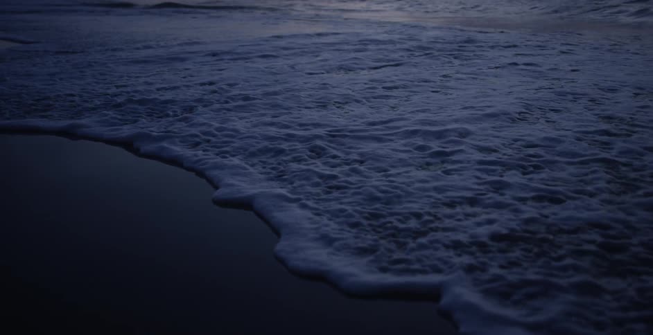 The tide rolls in on a beach