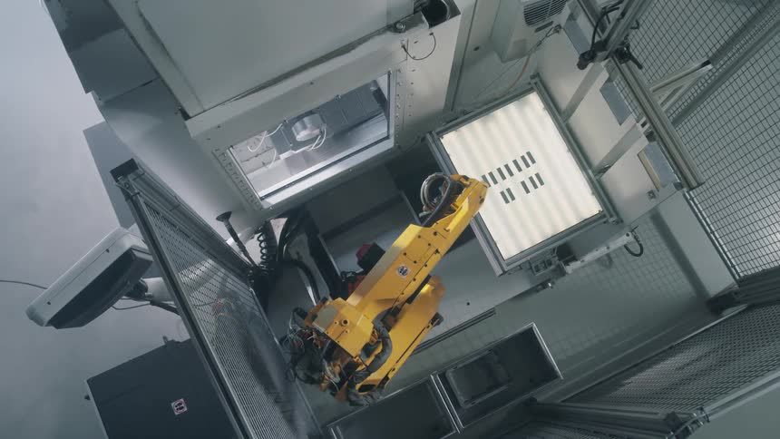 A yellow robotic arm doing some tasks in the laboratory
