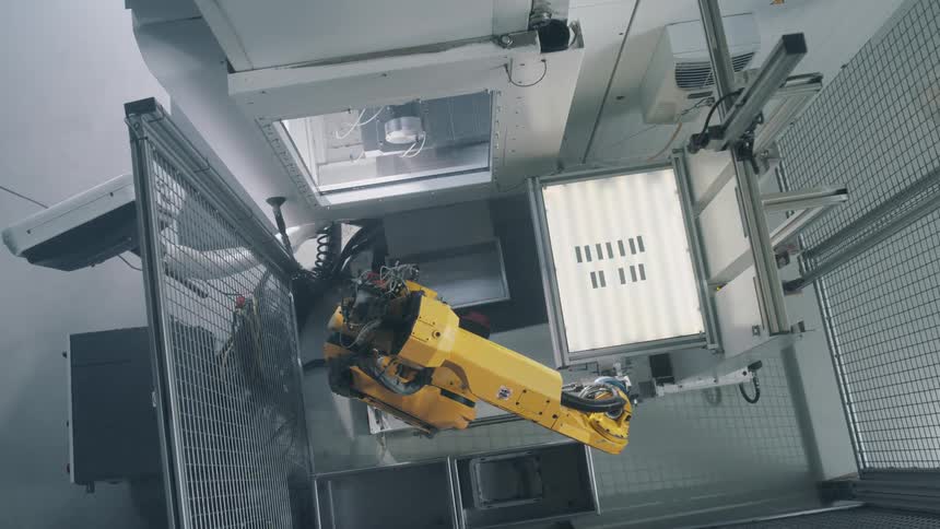 A robotic arm removing an object from a table