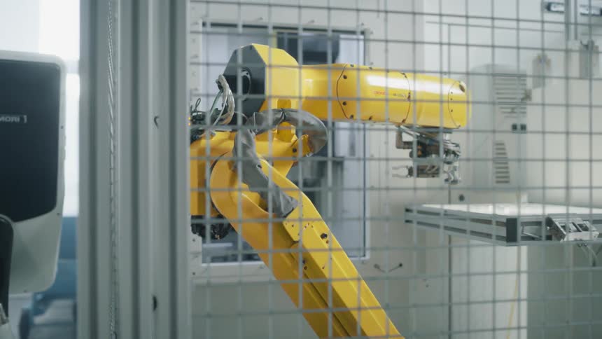 A footage of a yellow robotic arm in action