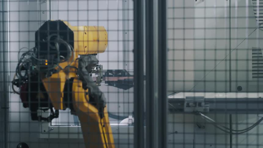 A robotic manipulator moving on the other side of a window