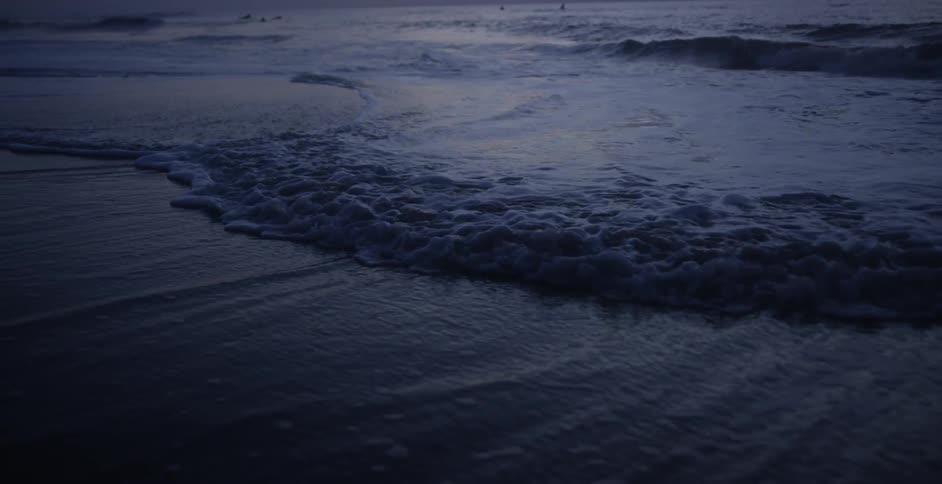 The tide slowly fills the sand on the beach
