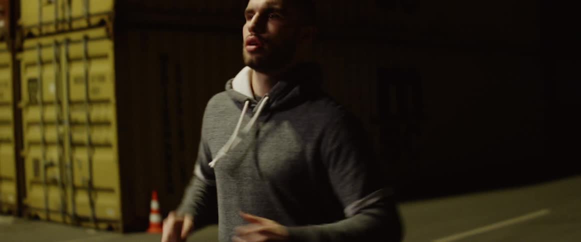 Man runs along the road at night