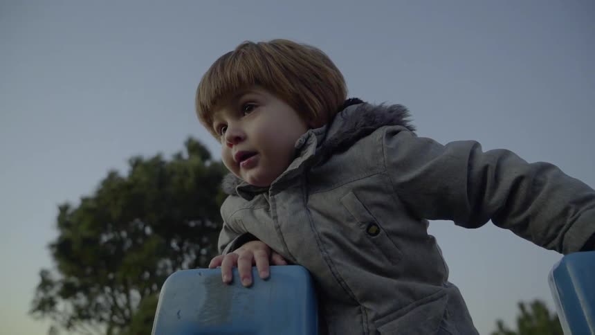 A boy is climbing up the slide
