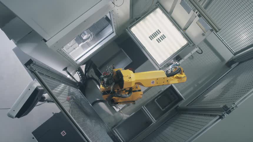 A robotic arm moves around in a confined space