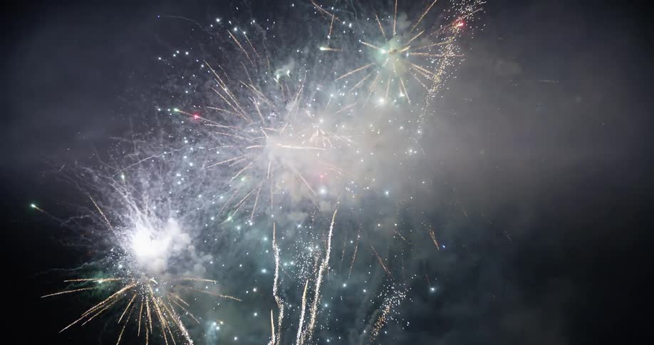 Sparkling fireworks shooting off into the night sky