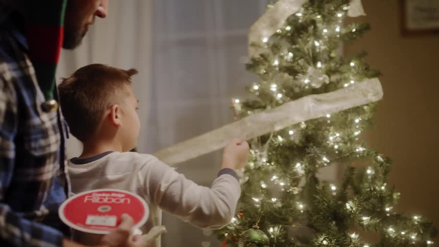 A family decorating the christmas tree