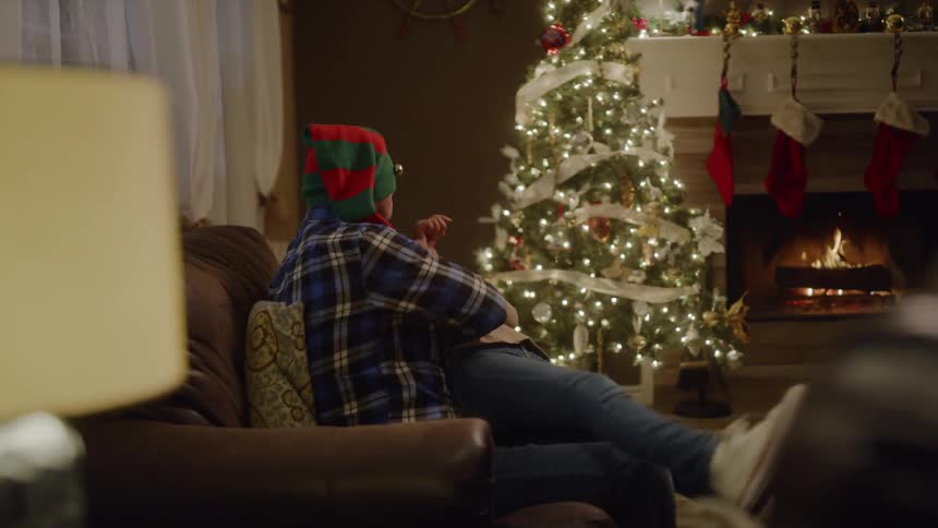 Father and daughter playing on the sofa at the christmas night