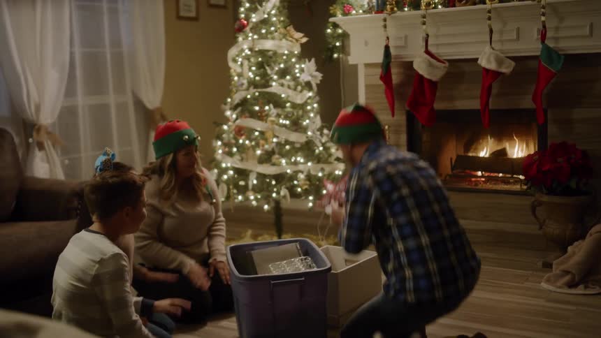 A family pulls on christmas ornaments together