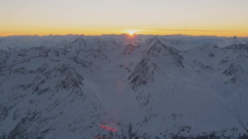A mountain range covered in snow stretches to the horizon