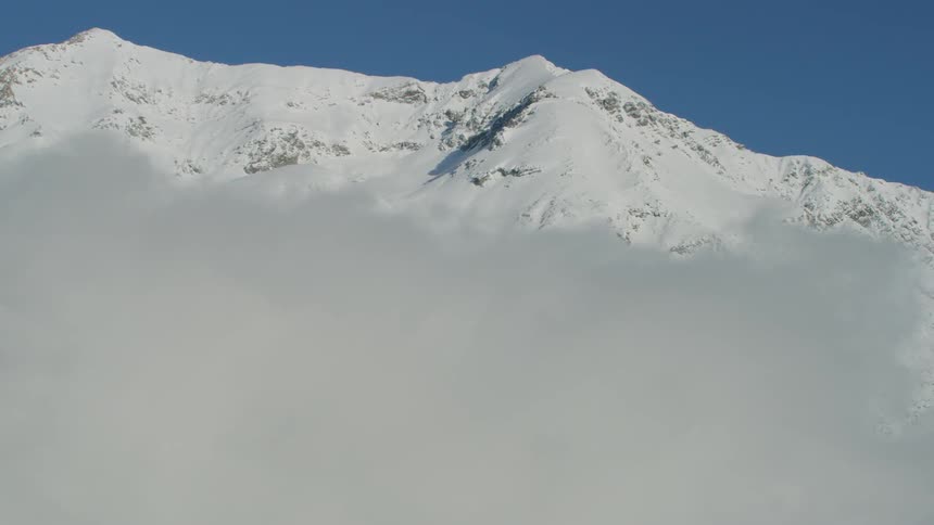 A scenery of mountain peak above the cloud