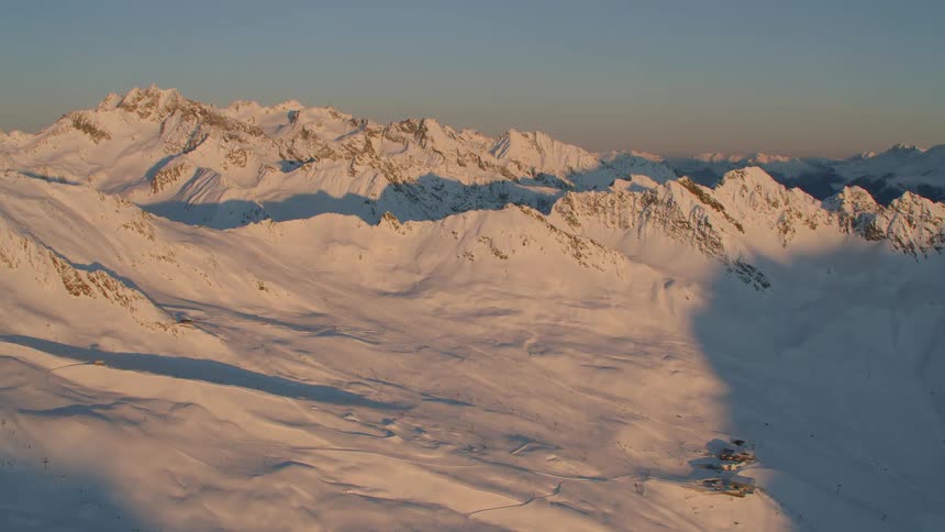An aerial scenery of snowy mountain range at the dawn