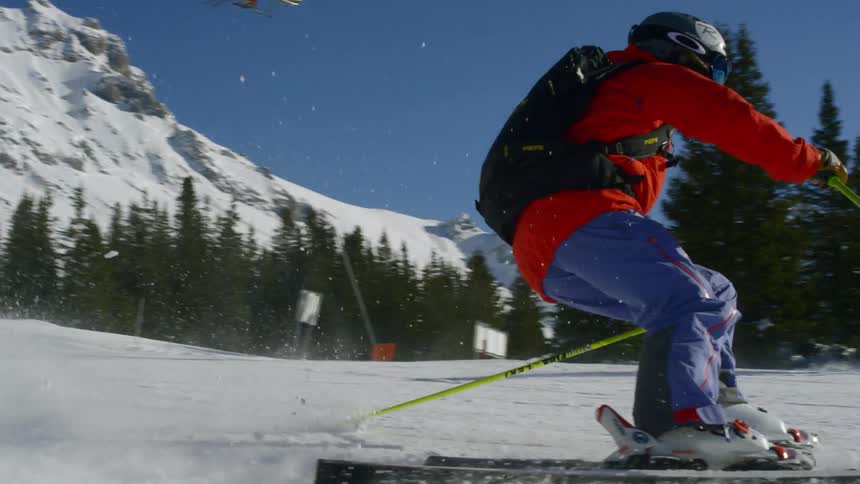 Two people ski around a simple snow covered area together
